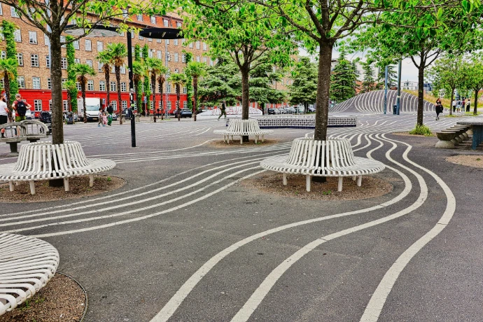 Modern park with wavy lines and white benches